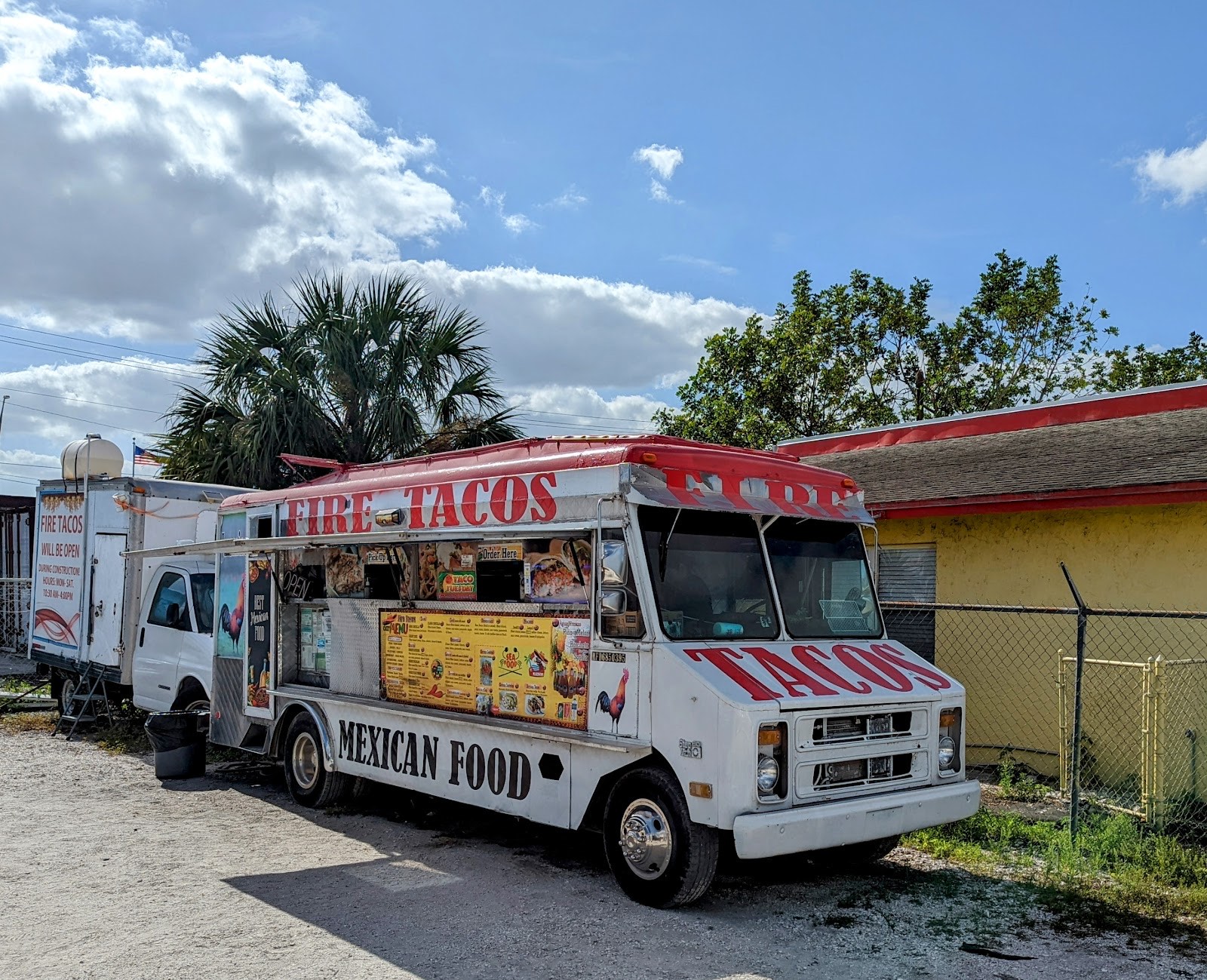 The Fire Tacos truck under blue Florida skies with its menu boards and Mexican Food lettering